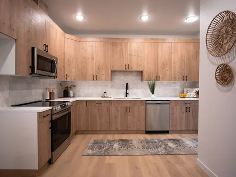 Finished kitchen with oak cabinets and white counters